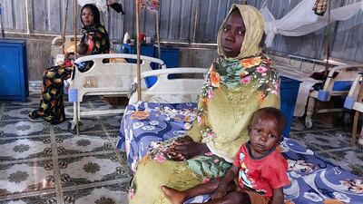 Women and a children waiting at a nutrition centre at the Kalma camp for the displaced outside Nyala, the provincial capital of South Darfur state. AFP