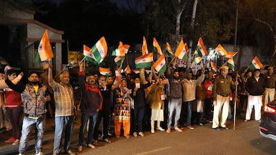 A crowd carrying flags gathers outside New Delhi's Tihar central prison as four men convicted of the 2012 New Delhi gang rape were hanged before dawn on March 20, 2020. AP Photo