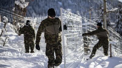 Army personnel set up security fences around the congress centre in Davos. EPA