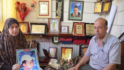 Suha Abu Khdeir and Hussein Khdeir hold a photo of their son Mohammed Abu Khdeir who was killed last year by Jewish vigilantes. Kate Shuttleworth for The National