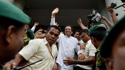 Sri Lanka’s former health minister Maithripala Sirisena waves to supporters in Colombo on November 21, 2014, shortly after defecting from the ruling party and declaring himself as the common opposition candidate to challenge President Mahinda Rajapaksa in January elections. Ishara S Kodikara / AFP