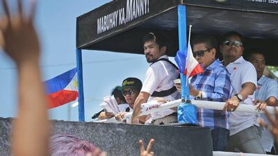 Manny Pacquiao is cheered during his return to the Philippines on Wednesday. Aaron Favila / AP / May 13, 2015