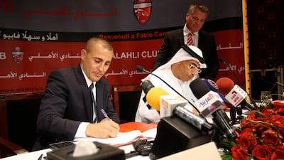 From left: Fabio Cannavaro of Al Ahli FC, chief executive Ahmed Khalifa, and Mark Bell, sporting director of Al Ahli FC, during a press conference in Dubai in 2010. Pawan Singh / The National