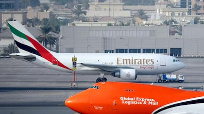 A TNT cargo plane lands on the runway at Dubai International Airport. Emirates has an alliance with the airline arm of the Dutch parcel service TNT Express. Andrew Parsons / The National
