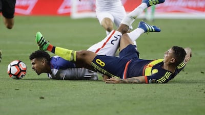 DeAndre Yedlin of United States, left, collides with Edwin Cardona of Colombia. Ezra Shaw / Getty Images