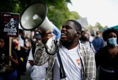 A man uses a megaphone as demonstrators march to Westminster during a Black Lives Matter protest. Reuters