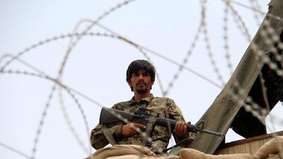 An Afghan soldier helps to secure an army base in Kandahar province on May 23, 2017, following an attack by militants in the district of Shah Wali Kot. Muhammad Sadiq / EPA