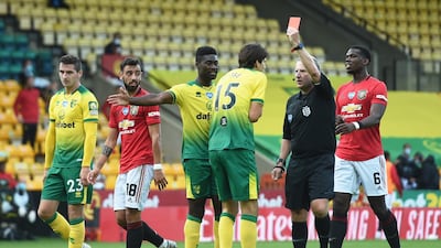 Norwich City's Timm Klose is shown a red card by referee Jon Moss. Reuters