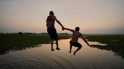 Boys leap into Dal Lake in Srinagar, Indian-controlled Kashmir. AP