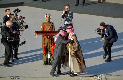 Jordan's Crown Prince Hussein kisses his father King Abdullah II before the start of a dinner held by the king. Reuters