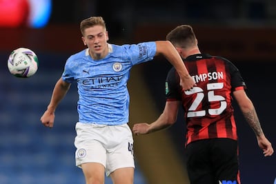 Manchester City's Liam Delap, left, battles with Bournemouth's Jack Simpson during the League Cup third round.