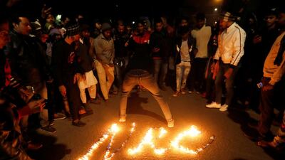 Demonstrators attend a protest against a new citizenship law, outside Jamia Millia Islamia university in New Delhi. Reuters