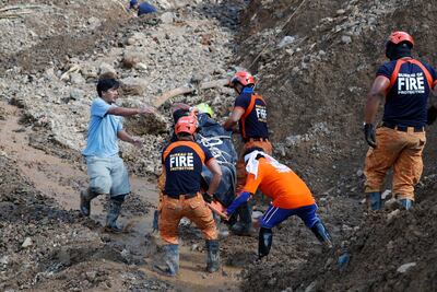 Rescuers carry the body of a victim killed in a landslide caused by Typhoon Mangkhut in Itogon town, Benguet Province, Philippines. Francis R Malasig / EPA