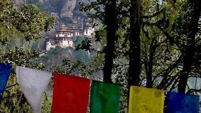 Prayer flags fly before the Taktsang Dzong, also known as the Tiger's Nest monastery, near Paro, Bhutan. AFP