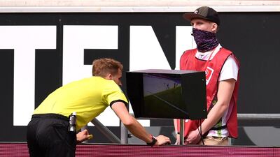 Referee Soren Storks refers to VAR during the Dusseldorf-Hoffenheim game. Reuters