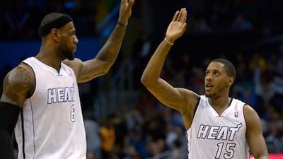 Miami Heat's Mario Chalmers is congratulated by LeBron James after his basket against Orlando Magic