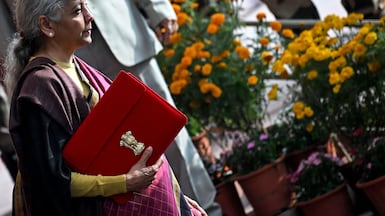 India's Finance Minister Nirmala Sitharaman holds a folder bearing the Government of India's emblem as she leaves her office to present the annual federal budget in parliament in New Delhi. Reuters