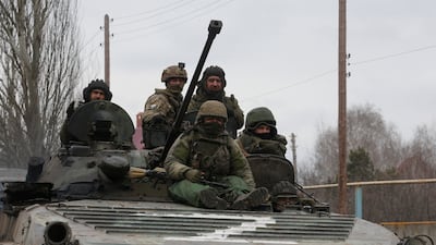 Pro-Russian troops in uniforms without insignia in an armoured vehicle with "Z" painted on its front in Donetsk, Ukraine. Reuters