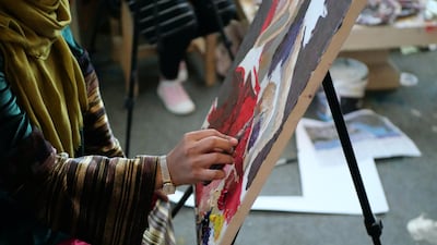 Artists sit and paint at the ArtLords Kabul headquarters where they are able to receive training and mentoring. Charlie Faulkner for The National