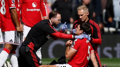 Manchester United's Harry Maguire receives treatment after taking a blow to the face in the first minute. Reuters