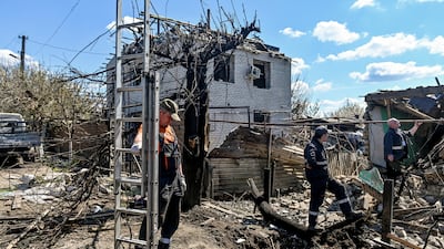 Emergency workers at the site of houses damaged by a missile attack in Zaporizhzhia, Ukraine. Reuters