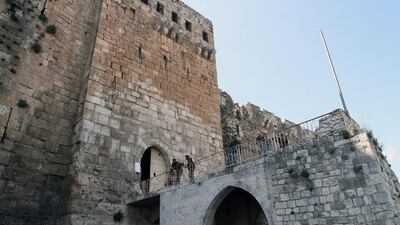 Syrian army soldiers stand guard at the entrance of the 'Krak des Chevaliers' the famous Crusader castle in Homs province on March 21. EPA