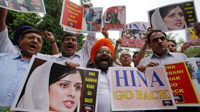 Members of the Fight against Terrorism Society hold posters and shout slogans during a protest against the visit of Pakistan's Foreign Minister Hina Rabbani Khar to India, in New Delhi July 27, 2011. Indian and Pakistani foreign ministers said on Wednesday they have a responsibility to mend ties between the nuclear-armed rival countries to reduce tension in the region, made all the more urgent with a U.S. troops drawdown in Afghanistan looming. REUTERS/Adnan Abidi (INDIA - Tags: POLITICS CIVIL UNREST)