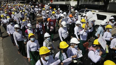 School teachers march holding placards during a protest against the military coup outside the Chinese Embassy in Yangon, Myanmar. EPA