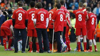Liverpool players wear Gerrard shirts as they wait for Steven Gerrard to be presented on the pitch after his final game at Anfield. Phil Noble / Reuters