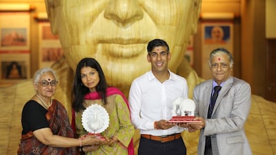 British Prime Minister Rishi Sunak and his wife Akshata Murty are presented with mementos at the temple. Photo: BAPS