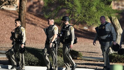 Police return to their vehicles after patrolling around the Mandalay Hotel where a gunman killed at least 50 people and wounded more than 200 others when he opened fire on a country music concert in Las Vegas, Nevada on October 2, 2017. Mark Ralston / AFP