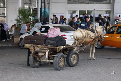 Foreign and dual citizens gather at the Rafah border crossing as they prepare to leave Gaza and enter Egypt. AFP