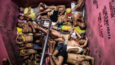 Prisoners sleep on a staircase in the Quezon City jail in Manila because of overcrowding. Noel Celis / AFP