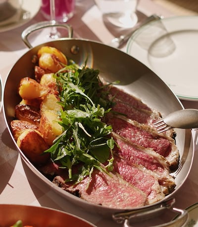 Sirloin beef steak in mushroom veal jus with a side of bone marrow toast, greens and roasted potatoes. Photo: Josette