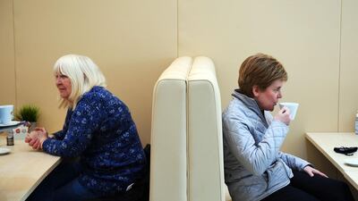 Nicola Sturgeon has a cup of tea as she campaigns in Glasgow. AFP