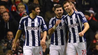 West Bromwich Albion defender Gareth McAuley (r) celebrates his goal against Liverpool with teammates Claudio Yacob and Shane Long.