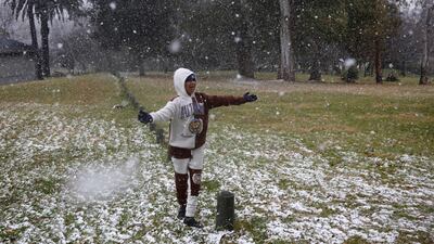 Gabriel Sussman enjoys the snowfall in Zoo Lake park. AFP