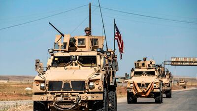 SYRIA: US military vehicles drive in a patrol along the M4 highway by the town of Tal Tamr and its countryside in Syria's northeastern Hasakeh province, near the border with Turkey, on May 20, 2020. AFP