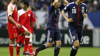 Japan's Shinji Okazaki, second right, celebrates his goal against Oman.