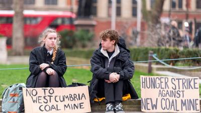 Protesters campaign against the UK's first new coal mine in 30 years outside parliament in London. Alamy