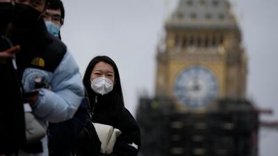 People queue for booster shots in London. AstraZeneca says it is developing a new vaccine to tackle the Omicron coronavirus variant. Photo: AP