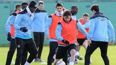 Owen Hargreaves, centre, is in the middle of the action during Manchester City's training session ahead of their Europa League match with Sporting.