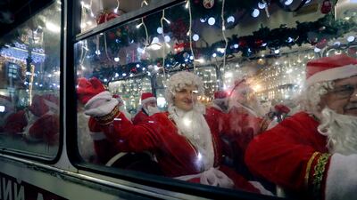 Musicians dressed as Father Frost (the Russian version of Santa Claus) take a bus along Nevsky Prospekt Avenue during festive celebrations in St Petersburg, Russia. EPA