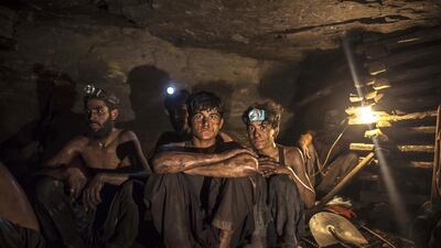 Miners pose for a photograph at the coal face inside a mine in Choa Saidan Shah, Punjab. Sara Farid / Reuters