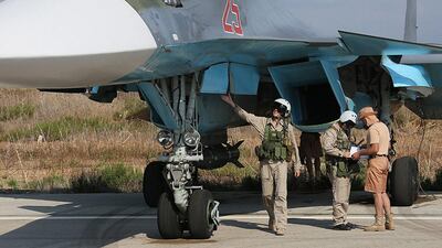 Russian pilots check their plane before the flight at a Syrian airbase, outside Latakia. EPA / Russian Defence Ministry Press Service