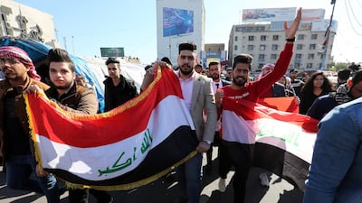 Iraqi protesters chant slogans and carry the Iraqi national flag during ongoing anti-government protests at the Al Tahrir square in central Baghdad. EPA