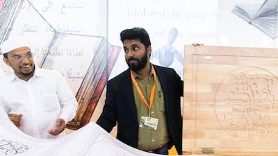 SHARJAH, UNITED ARAB EMIRATES. 30 October 2019. Cartoonist and Guinness record holder M Dileef’s latest Guinness pursuit involves creating the world’s largest handwritten Quran. His dream is to write the holy text that runs a kilometre long. His quran is on display at the 38th Sharjah International Book Fair edition at Expo Centre Sharjah, offering more than 1.6 million titles to publishers as well as eager readers of all ages. (Photo: Reem Mohammed/The National) Reporter: Section: