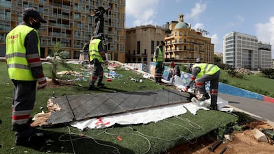 Workers clean the area around Martyrs' Square after Lebanese security forces cleared away a protest camp and reopened roads blocked by demonstrators since protests against the governing elite started in October, in Beirut. REUTERS