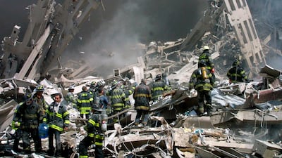 Firefighters make their way through the rubble after two airliners crashed into the World Trade Centre in New York on September 11, 2001. AP