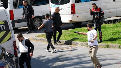 A man brandishing a gun near the building housing the Israeli consulate in Istanbul. Reuters